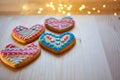 Freshly baked delicious gingerbread cookies shape of heart with colored patterns