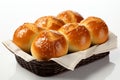 Freshly baked dinner rolls resting elegantly on a spotless white background Royalty Free Stock Photo