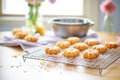 freshly baked donuts on a cooling wire rack, kitchen setting