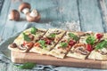 Freshly baked flammkuchen, traditional french tarte flambee or german pizza in a vegetarian recipe with mushrooms, cream cheese, Royalty Free Stock Photo
