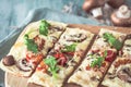 Freshly baked flammkuchen, traditional french tarte flambee or german pizza in a vegetarian recipe with mushrooms, cream cheese, Royalty Free Stock Photo