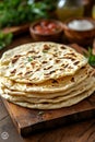 Freshly Baked Flatbread Stacked on a Wooden Board Ready to Eat Royalty Free Stock Photo