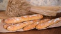 Freshly baked French baguettes on wooden table.