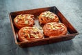 Freshly baked French raisin buns. Pains aux raisins on a vintage baking tray