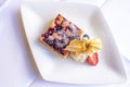 Freshly baked fruit cake with whipped cream and powdered sugar Royalty Free Stock Photo