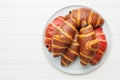 Freshly Baked fruity and Chocolate Croissants on plate on kitchen table. Top view