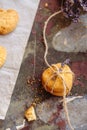 Freshly baked heart-shaped cookies on parchment paper, lavender flower