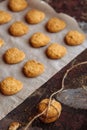 Freshly baked heart-shaped cookies on parchment paper, lavender flower