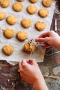 Freshly baked heart-shaped cookies on parchment paper, lavender flower