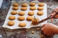 Freshly baked heart-shaped cookies on parchment paper, lavender flower