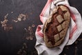 Freshly baked homemade bread on artisan sourdough rye on brawn stone or concrete background. Top view. Food cooking background. Co