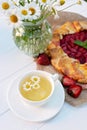 Freshly baked homemade galette or open strawberry pie and fresh mint leaves with a cup of chamomile herbal tea, summer food. Soft Royalty Free Stock Photo