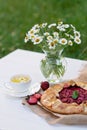 Freshly baked homemade galette or open strawberry pie and fresh mint leaves with a cup of chamomile herbal tea, summer food. Soft Royalty Free Stock Photo