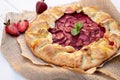 Freshly baked homemade galette or open strawberry pie and fresh mint leaves, summer food. Soft selective focus Royalty Free Stock Photo