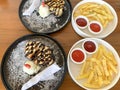 freshly baked homemade heart shaped Belgian waffles, covered with chocolate syrup and vanilla ice cream with sliced of straw berry Royalty Free Stock Photo