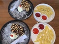 freshly baked homemade heart shaped Belgian waffles, covered with chocolate syrup and vanilla ice cream with sliced of straw berry Royalty Free Stock Photo