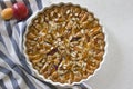 Freshly baked homemade pie with apricots and peaches on a light background. Top view, natural light