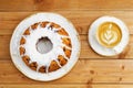 Freshly baked homemade raspberry cake with white sugar icing and cup of coffee on wooden table. Royalty Free Stock Photo