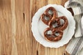 Freshly Baked Homemade Soft Pretzel with Salt on Rustic Table. Perfect for Octoberfest. Top View with Copy Space