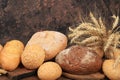 Freshly baked homemade sourdough bread with crispy crust and ears of rye and wheat on an old wooden background with place for text Royalty Free Stock Photo