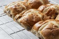 Freshly baked hot cross buns on a metal cooling rack.  Easter food Royalty Free Stock Photo