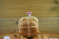 Freshly baked hot cross buns with miniature person figurine with sign indicating i love Easter