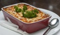 Fresh lasagna dish serving with garnish