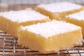 Freshly baked lemon squares cooling on wire rack