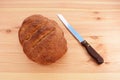 Freshly baked loaf with a bread knife
