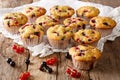 Freshly baked muffins with black and red currant berries close-up. horizontal Royalty Free Stock Photo