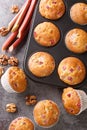 Freshly baked muffins with rhubarb and walnuts close-up in a baking dish. Vertical top view Royalty Free Stock Photo