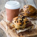 Freshly baked muffins served with coffee in a disposable cup. Royalty Free Stock Photo