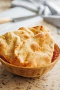 Freshly Baked Naan Bread in basket on kitchen table Royalty Free Stock Photo