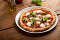 Freshly baked Neapolitan pizza with mozzarella and basil