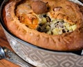 Freshly baked pie with duck meat, potatoes and onions.