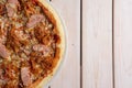 Freshly baked pizza with beef and fried onion