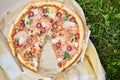 Delicious Pizza With Tomato, Cheese, and Greens in a Cardboard Box Outdoors