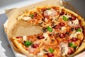 Delicious Pizza With Tomato, Cheese, and Greens in a Cardboard Box Outdoors