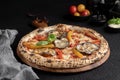 fresh baked pizza with toppings on a wooden board for serving Royalty Free Stock Photo