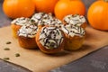 Freshly baked pumpkin muffins decorated ghosts, spiderweb for Halloween celebration. Autumn composition with pumpkins, cupcakes on