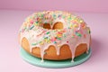 freshly baked ring cake with pastel buttercream and sprinkles on top Royalty Free Stock Photo