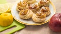 Freshly baked round buns with cinnamon and Apple on a plate, homemade cakes Royalty Free Stock Photo