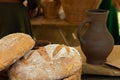 Freshly baked rustic bread lies against a background of a jug filled with milk, design natural rustic breakfast