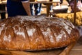 Freshly baked rustic brown bread closeup traditional pastries on wooden background