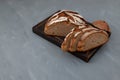 Freshly baked rye bread on brown cutting board. Healthy yeast-free bread, Place for text