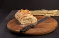 Freshly baked rye bread on a wooden board. Fresh bread on table close-up. Fresh bread on the kitchen table Whole grain bread put Royalty Free Stock Photo