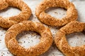 Freshly baked simit on a baking sheet - a close-up sesame bun Turkish bagel - Gevrek or Kuluri. Traditional white bread with