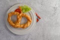 Freshly baked soft pretzel on white dish