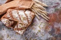 Freshly baked sourdough rye flour bread with sunflower and pumpkin seeds on a brown napkin. Ears of wheat. Copy space Royalty Free Stock Photo