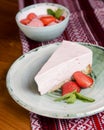 Freshly baked strawberry cheesecake with fresh strawberries and mint. Served on a plate. Royalty Free Stock Photo